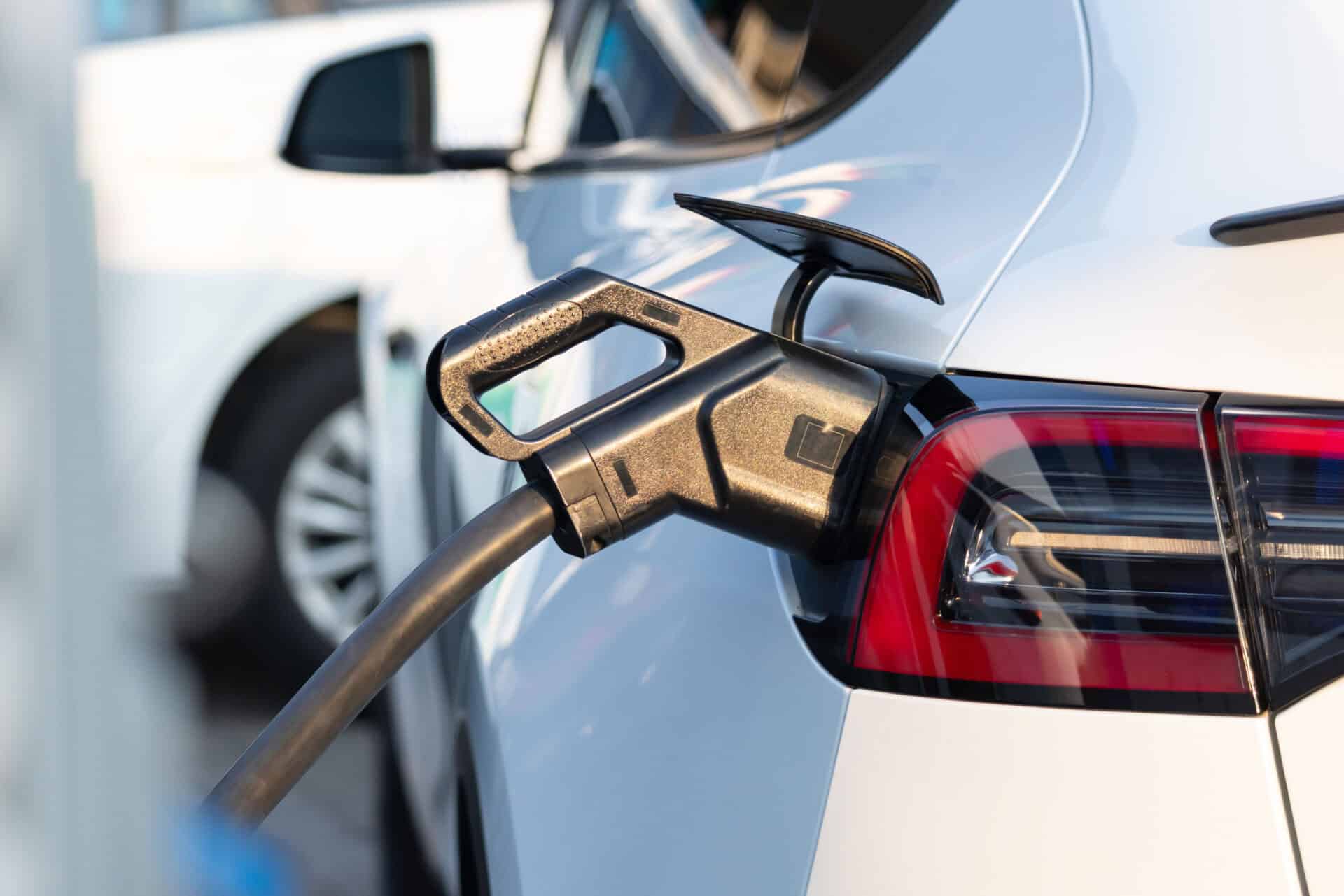 A EV car is being charged at a charging station.
